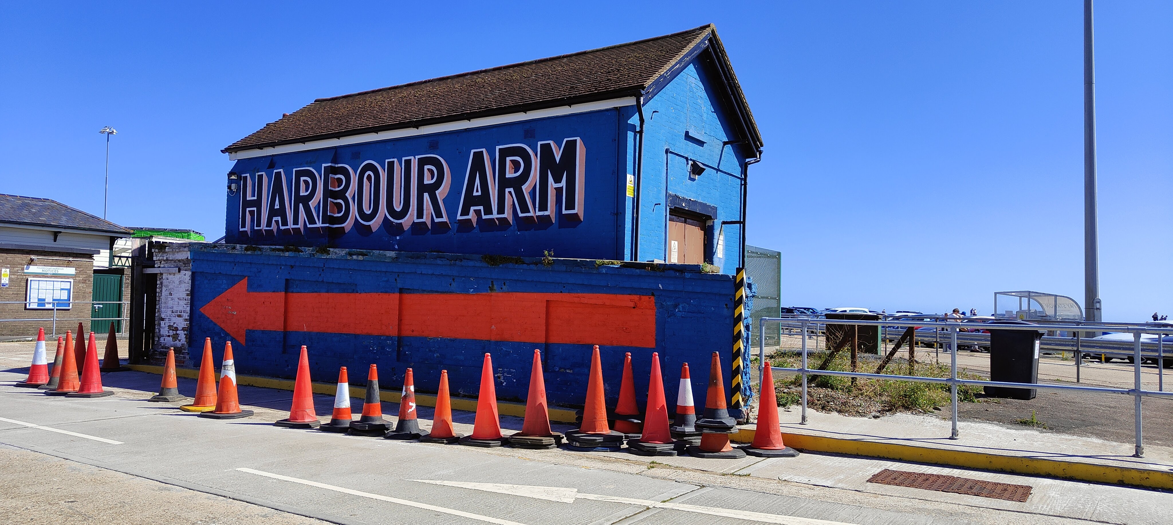 Picture of an old fish hut painted in blue with an arrow