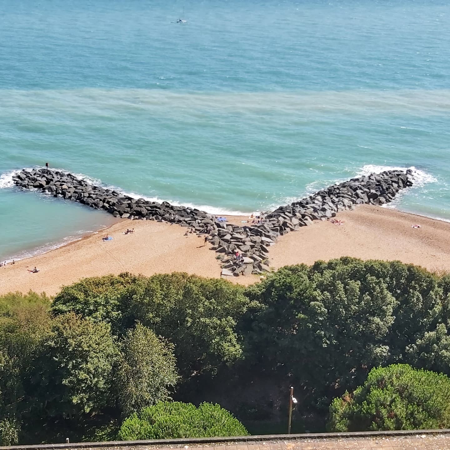 Picture of rocks in the sea in a shape of a tail