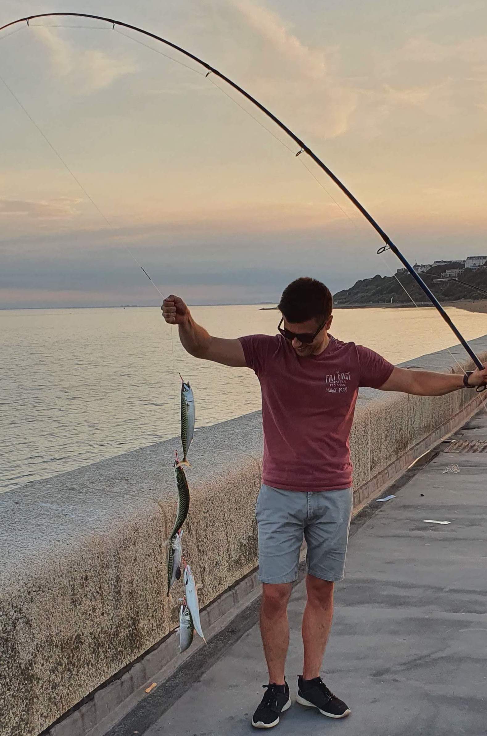 Picture of a man fishing on the Harbour Arm